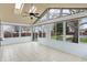 Bright sunroom featuring tile floors, skylights, and multiple windows showcasing backyard views at 6958 W Brier Creek Dr, New Palestine, IN 46163
