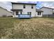 Large backyard with blue deck, table, and exterior of home at 7130 English Birch Ln, Indianapolis, IN 46268