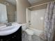 Neutral bathroom featuring a large sink, toilet, and shower with curtain at 7130 English Birch Ln, Indianapolis, IN 46268