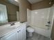 Bathroom with white vanity, mirror, and shower-tub combo at 7130 English Birch Ln, Indianapolis, IN 46268