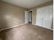 Bedroom featuring neutral carpet and walls with a window allowing ample natural light at 7130 English Birch Ln, Indianapolis, IN 46268