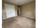 Neutral bedroom featuring wall-to-wall carpeting, an entry door, and closet at 7130 English Birch Ln, Indianapolis, IN 46268