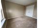 Neutral bedroom featuring wall-to-wall carpeting, a window, and a closet at 7130 English Birch Ln, Indianapolis, IN 46268