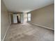 Spacious bedroom featuring neutral walls, carpet, and double doors to adjacent bathroom at 7130 English Birch Ln, Indianapolis, IN 46268