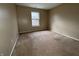 Bedroom featuring neutral carpet and walls with a window allowing ample natural light at 7130 English Birch Ln, Indianapolis, IN 46268