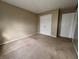 Bedroom featuring neutral carpet and walls and a closet at 7130 English Birch Ln, Indianapolis, IN 46268
