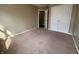 Empty bedroom featuring a closet and neutral-colored carpet at 7130 English Birch Ln, Indianapolis, IN 46268