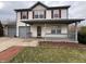 Charming two-story home featuring red shutters, a covered porch, and a convenient attached garage at 7130 English Birch Ln, Indianapolis, IN 46268
