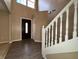 Inviting foyer with soaring ceilings, wood floors, and a staircase creates a grand entrance at 7130 English Birch Ln, Indianapolis, IN 46268