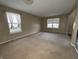 Open living area with neutral walls, plush carpeting, and large windows create a comfortable atmosphere at 7130 English Birch Ln, Indianapolis, IN 46268