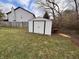 White storage shed in backyard with table next to it at 7130 English Birch Ln, Indianapolis, IN 46268