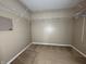 Neutral walk-in closet featuring carpet flooring and metal shelving at 7130 English Birch Ln, Indianapolis, IN 46268