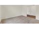 A bedroom featuring neutral carpet with a door leading to a wood-floored hallway at 7170 Rose Hill Ave, Brownsburg, IN 46112