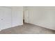 A carpeted bedroom featuring a double door closet and white trim at 7170 Rose Hill Ave, Brownsburg, IN 46112