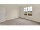 Cozy bedroom filled with natural light from a large window overlooking a neighborhood landscape at 7170 Rose Hill Ave, Brownsburg, IN 46112