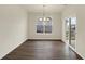 Dining room with modern chandelier, hardwood floors, and natural light shining through the window at 7170 Rose Hill Ave, Brownsburg, IN 46112