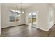 Dining room with hardwood floors, modern chandelier, and a sliding glass door leading to the patio at 7170 Rose Hill Ave, Brownsburg, IN 46112