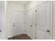 Entryway featuring multiple doors, wood-look flooring, and neutral wall paint at 7170 Rose Hill Ave, Brownsburg, IN 46112