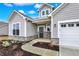 Inviting front entry with a cozy porch, stone accents, and a beautifully designed walkway at 7170 Rose Hill Ave, Brownsburg, IN 46112