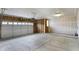 Spacious garage featuring concrete floor, exposed framing, and a large sectional garage door at 7170 Rose Hill Ave, Brownsburg, IN 46112