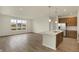 Open-concept kitchen featuring an island with stainless steel appliances and abundant natural light at 7170 Rose Hill Ave, Brownsburg, IN 46112
