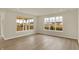 Bright living room filled with natural light through large windows, and hardwood floors at 7170 Rose Hill Ave, Brownsburg, IN 46112