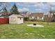 Backyard with shed, fire pit, and green lawn at 7347 Blue Creek S Dr, Indianapolis, IN 46256