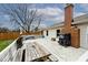 Backyard deck with grill, picnic table, and other furniture, perfect for summer relaxing at 7347 Blue Creek S Dr, Indianapolis, IN 46256
