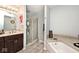 Bathroom features a bathtub, glass shower, and wood vanity at 7347 Blue Creek S Dr, Indianapolis, IN 46256