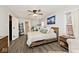 Spacious bedroom with hardwood floors, a cozy bed, and ample natural light at 7347 Blue Creek S Dr, Indianapolis, IN 46256
