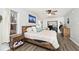 Bedroom features hardwood floors, neutral walls, and a large bed at 7347 Blue Creek S Dr, Indianapolis, IN 46256