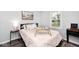 This cozy bedroom offers a queen bed, fresh decor, and a view to the outdoor landscape at 7347 Blue Creek S Dr, Indianapolis, IN 46256