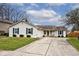 Charming single-story home featuring a well-maintained lawn, inviting curb appeal, and attached garage at 7347 Blue Creek S Dr, Indianapolis, IN 46256
