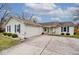 A single-story home has blue shutters, a driveway, and a white exterior with an attached garage at 7347 Blue Creek S Dr, Indianapolis, IN 46256