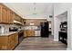 Well-lit kitchen with wooden cabinets, stainless steel appliances, and modern chandelier at 7347 Blue Creek S Dr, Indianapolis, IN 46256