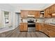 Kitchen features wooden cabinets, stainless steel appliances, and modern style at 7347 Blue Creek S Dr, Indianapolis, IN 46256