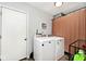 Laundry room with a washing machine, dryer, and door to the side at 7347 Blue Creek S Dr, Indianapolis, IN 46256