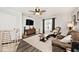 This living room has hardwood floors and a ceiling fan and is a comfy place to relax at 7347 Blue Creek S Dr, Indianapolis, IN 46256