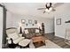 The living room features a decorative ceiling fan, plush seating, and natural lighting at 7347 Blue Creek S Dr, Indianapolis, IN 46256
