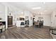 Open floor plan showcases a living room, fireplace, and adjacent dining area with hardwood floors at 7347 Blue Creek S Dr, Indianapolis, IN 46256