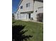 Fenced in backyard with grass, rocks, patio, and sliding glass doors at 8160 Shores Edge Way, Indianapolis, IN 46237