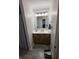 Bathroom with a single sink vanity, neutral tile flooring, and bright lighting at 8160 Shores Edge Way, Indianapolis, IN 46237