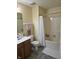 Well-lit bathroom featuring a tub-shower combo with white shower curtain and vanity with light wood cabinets at 8160 Shores Edge Way, Indianapolis, IN 46237