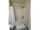 Bathroom shower featuring tiled surround, showerhead, white shower curtain, and bathmat at 8160 Shores Edge Way, Indianapolis, IN 46237