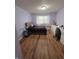 Bedroom with wood floors, desk, natural light, and a gray upholstered bed at 8160 Shores Edge Way, Indianapolis, IN 46237