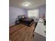 Bedroom with laminate wood flooring, desk, and a window at 8160 Shores Edge Way, Indianapolis, IN 46237