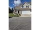 Two-story home with an attached garage and well-kept lawn under a sunny, blue sky at 8160 Shores Edge Way, Indianapolis, IN 46237