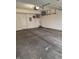 Spacious garage with concrete floor, overhead lighting, and storage shelving at 8160 Shores Edge Way, Indianapolis, IN 46237