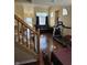 Open concept living area featuring hardwood floors, a stairway, and a comfortable seating area at 8160 Shores Edge Way, Indianapolis, IN 46237