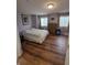 Inviting bedroom features wood floors, a comfortable bed, and plenty of natural light at 8160 Shores Edge Way, Indianapolis, IN 46237
